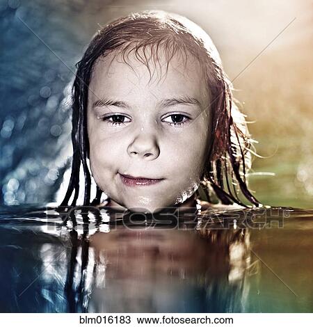 Stock Image - Caucasian girl swimming in water. Fotosearch