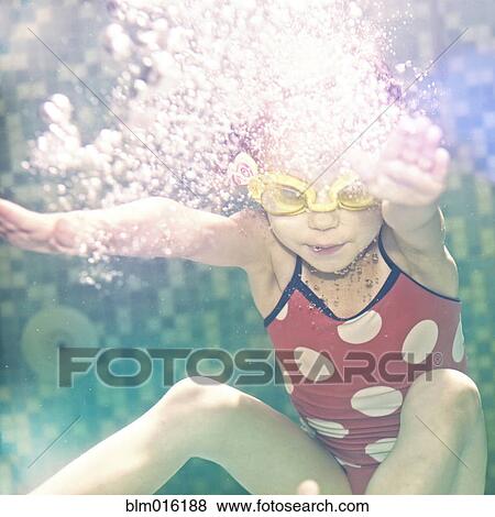 Caucasian girl swimming under water View Large Photo Image Stock Photo - Caucasian girl swimming under water. Fotosearch