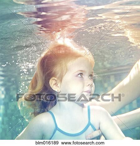 Caucasian girl swimming under water View Large Photo Image Stock Photo - Caucasian girl swimming under water. Fotosearch