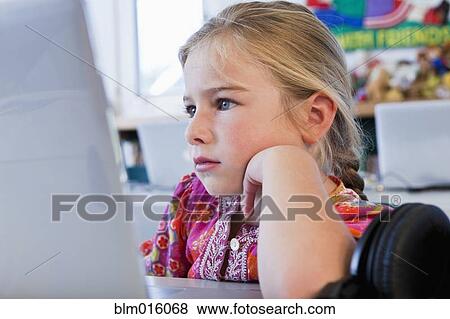 Stock Photo - Caucasian girl using computer. Fotosearch