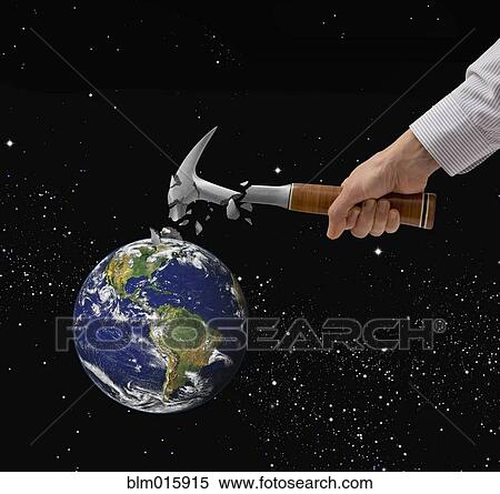 Stock Photography - Caucasian man breaking hammer on planet earth. Fotosearch