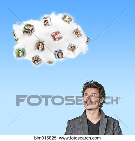 Caucasian man looking at cloud containing cubes with pictures of people View Large Photo Image Stock Photography - Caucasian man looking at cloud containing cubes with pictures of people. Fotosearch