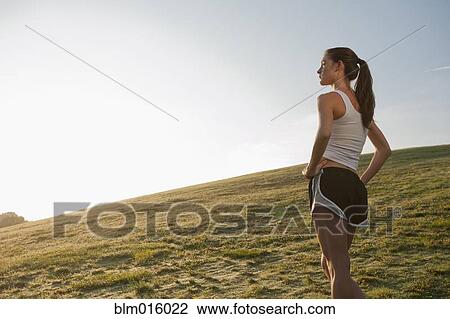 Caucasian runner standing in field View Large Photo Image Stock Image - Caucasian runner standing in field. Fotosearch