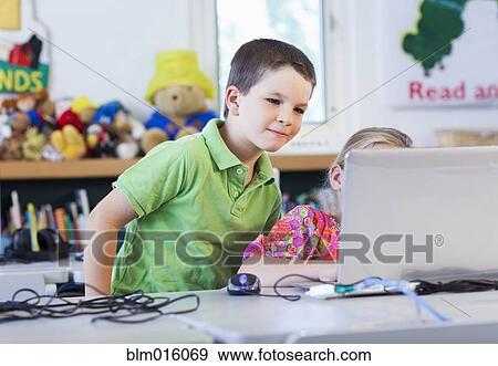 Caucasian students using laptop together View Large Photo Image Stock Photo - Caucasian students using laptop together. Fotosearch
