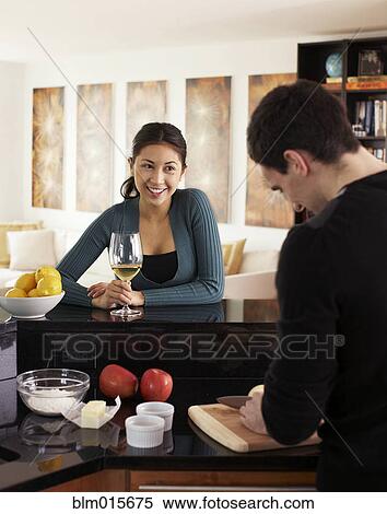 Couple cooking together in kitchen View Large Photo Image Stock Photography - Couple cooking together in kitchen. Fotosearch