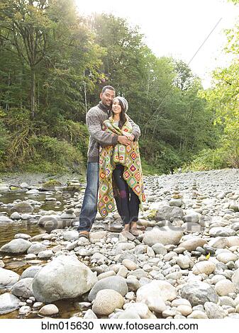 Couple hugging near stream View Large Photo Image Stock Image - Couple hugging near stream. Fotosearch