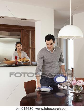 Stock Image - Couple preparing dinner together. Fotosearch