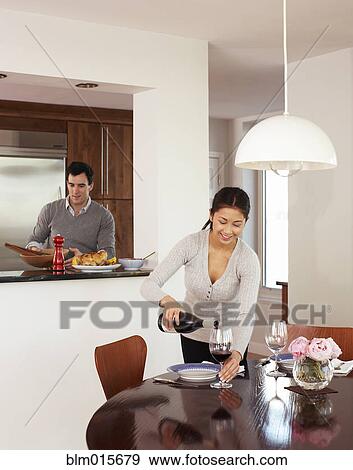 Stock Photo - Couple preparing dinner together. Fotosearch