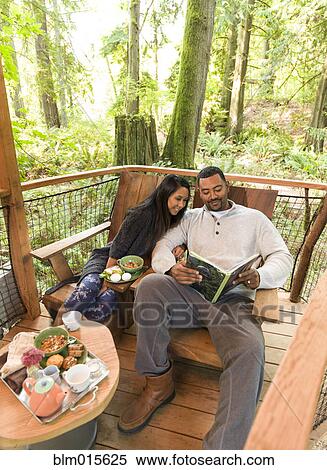 Stock Photography - Couple relaxing together on deck. Fotosearch