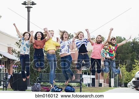 Friends hanging out together and jumping View Large Photo Image Stock Image - Friends hanging out together and jumping. Fotosearch