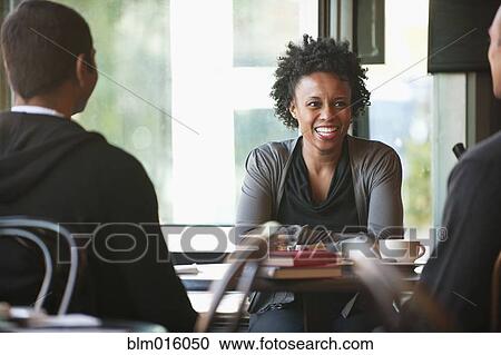 Friends sitting together in cafe View Large Photo Image Stock Image - Friends sitting together in cafe. Fotosearch