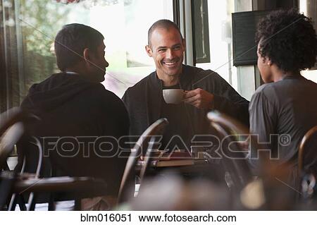 Friends sitting together in cafe View Large Photo Image Stock Image - Friends sitting together in cafe. Fotosearch
