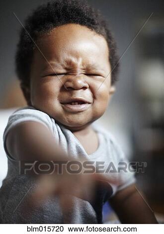 Grimacing African American baby View Large Photo Image Stock Image - Grimacing African American baby. Fotosearch