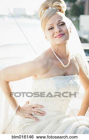 Stock Photograph - Hispanic bride with hands on hips. Fotosearch
