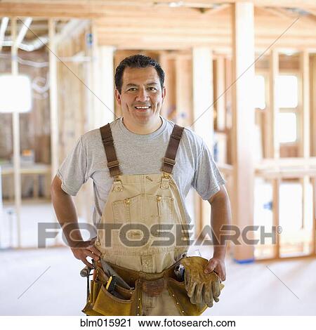 Hispanic construction worker in unfinished room View Large Photo Image Stock Image - Hispanic construction worker in unfinished room. Fotosearch