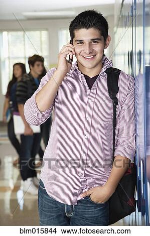Picture - Hispanic high school student talking on cell phone. Fotosearch
