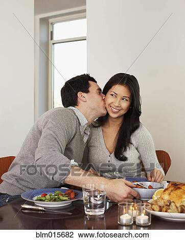 Husband kissing wife at dinner table View Large Photo Image Stock Image - Husband kissing wife at dinner table. Fotosearch