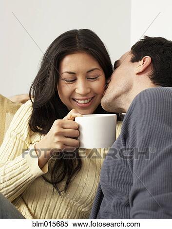 Husband kissing wife drinking coffee View Large Photo Image Stock Photography - Husband kissing wife drinking coffee. Fotosearch