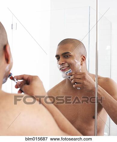 Man shaving in bathroom mirror View Large Photo Image Stock Photo - Man shaving in bathroom mirror. Fotosearch