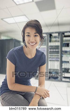 Mixed race businesswoman in server room View Large Photo Image Stock Photo - Mixed race businesswoman in server room. Fotosearch