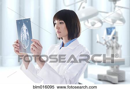 Mixed race doctor looking at digital tablet in operating room View Large Photo Image Stock Photography - Mixed race doctor looking at digital tablet in operating room. Fotosearch