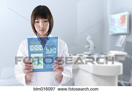 Mixed race doctor using digital tablet in laboratory View Large Photo Image Stock Photo - Mixed race doctor using digital tablet in laboratory. Fotosearch
