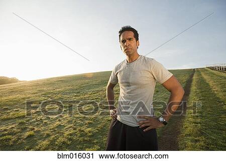 Mixed race runner standing in field View Large Photo Image Stock Image - Mixed race runner standing in field. Fotosearch