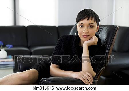 Stock Photograph - Serious businesswoman sitting in chair. Fotosearch