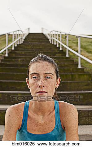 Serious Caucasian woman sitting on steps View Large Photo Image Stock Photograph - Serious Caucasian woman sitting on steps. Fotosearch