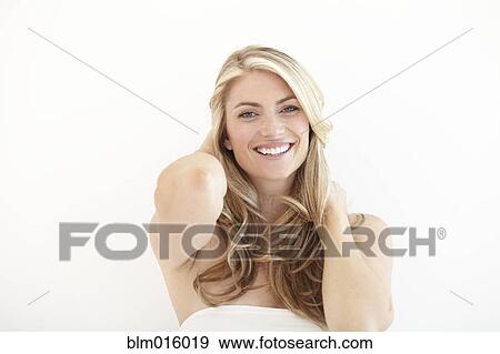 Stock Photo - Smiling Caucasian woman with head in hands. Fotosearch