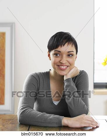 Smiling woman with hand on chin View Large Photo Image Stock Image - Smiling woman with hand on chin. Fotosearch