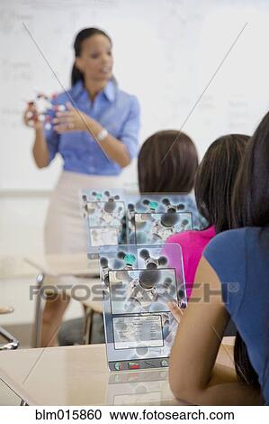 Students using digital tablets in classroom View Large Photo Image Stock Image - Students using digital tablets in classroom. Fotosearch