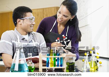 Teacher and student working with chemicals in classroom View Large Photo Image Stock Image - Teacher and student working with chemicals in classroom. Fotosearch