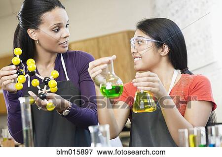 Teacher and student working with chemicals in classroom View Large Photo Image Stock Photo - Teacher and student working with chemicals in classroom. Fotosearch