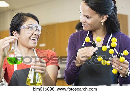 Stock Photo - Teacher and student working with chemicals in classroom. Fotosearch