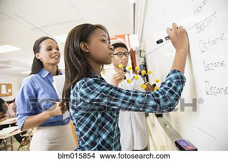 Teacher explaining chemistry model to students View Large Photo Image Picture - Teacher explaining chemistry model to students. Fotosearch