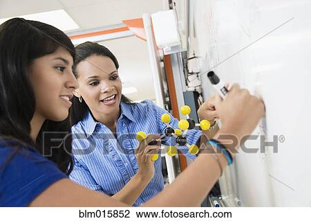 Teacher explaining chemistry model to student View Large Photo Image Stock Image - Teacher explaining chemistry model to student. Fotosearch