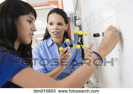 Teacher explaining chemistry model to student View Large Photo Image Stock Image - Teacher explaining chemistry model to student. Fotosearch