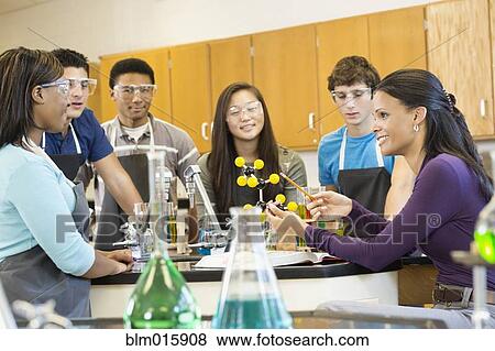 Teacher explaining chemistry model to students View Large Photo Image Stock Photo - Teacher explaining chemistry model to students. Fotosearch