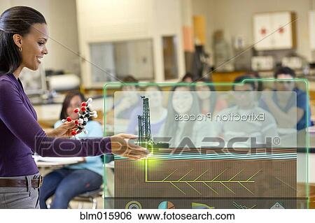 Stock Photograph - Teacher explaining the extraction process to classroom. Fotosearch