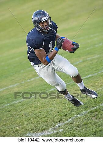 African American football player carrying ball View Large Photo Image Stock Image - African American football player carrying ball. Fotosearch
