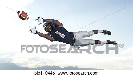 African American football player catching ball View Large Photo Image Stock Photography - African American football player catching ball. Fotosearch
