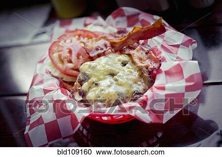 Stock Image - Bacon cheeseburger in basket. Fotosearch