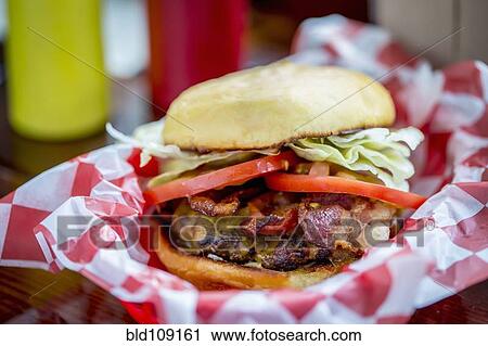 Stock Image - Bacon cheeseburger in basket. Fotosearch