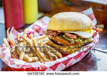 Basket of french fries with cheeseburger and egg View Large Photo Image Stock Photography - Basket of french fries with cheeseburger and egg. Fotosearch