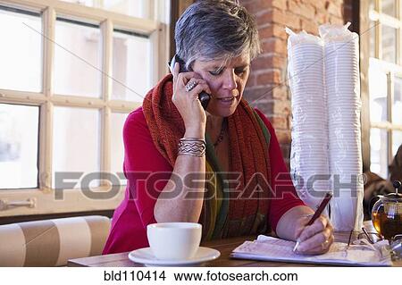 Picture - Caucasian businesswoman working in cafe. Fotosearch