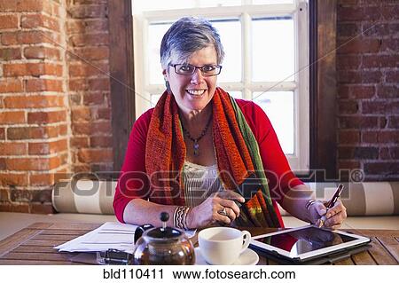 Caucasian businesswoman working in cafe View Large Photo Image Stock Image - Caucasian businesswoman working in cafe. Fotosearch