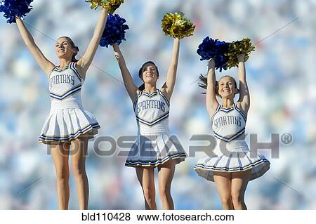 Caucasian cheerleaders on sidelines at football game View Large Photo Image Stock Photo - Caucasian cheerleaders on sidelines at football game. Fotosearch