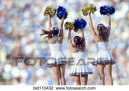 Stock Image - Caucasian cheerleaders posing together. Fotosearch