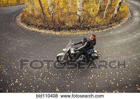 Caucasian couple riding motorcycle View Large Photo Image Stock Photo - Caucasian couple riding motorcycle. Fotosearch